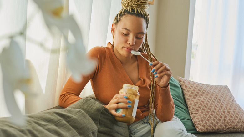 Woman eating peanut butter