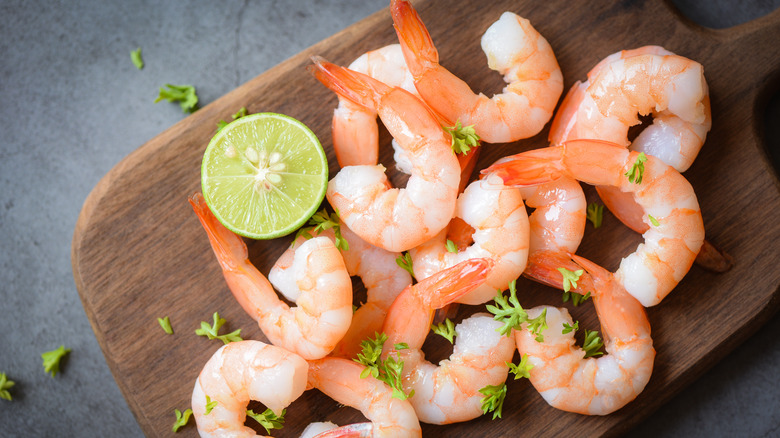 A pile of shrimp on a cutting board