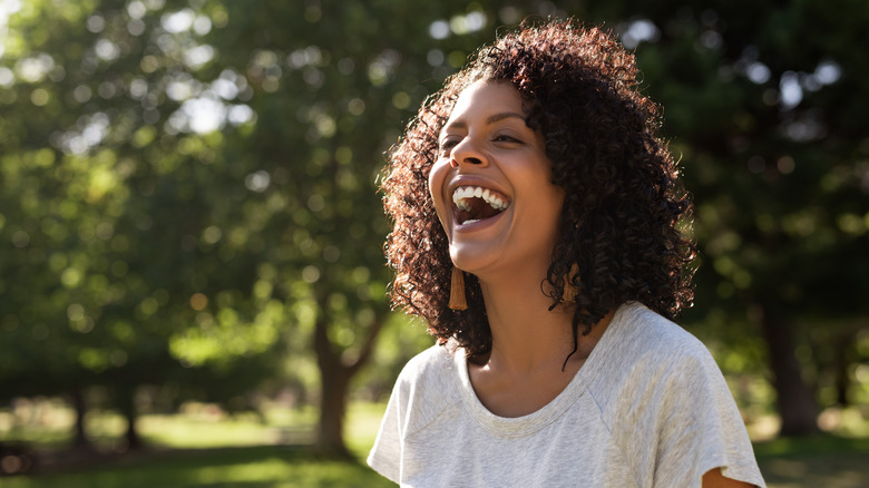 Woman laughing outside 