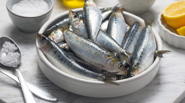 sardines in a bowl with salt and lemons