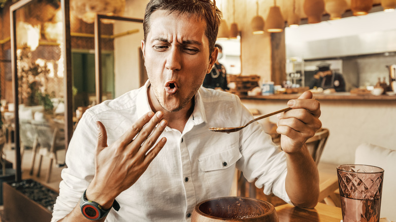 man eating spicy food