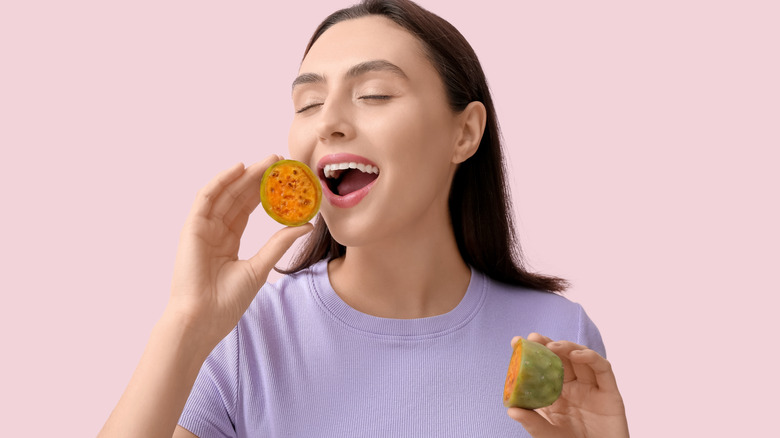 young woman eating a prickly pear
