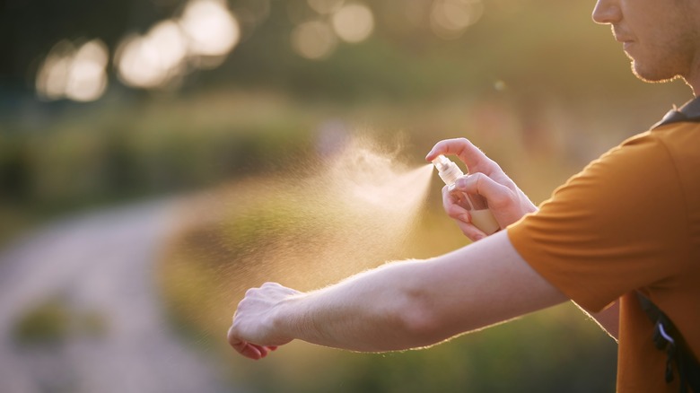 Man spraying arms