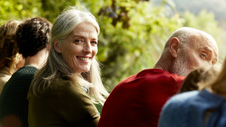 smiling older adult with a group