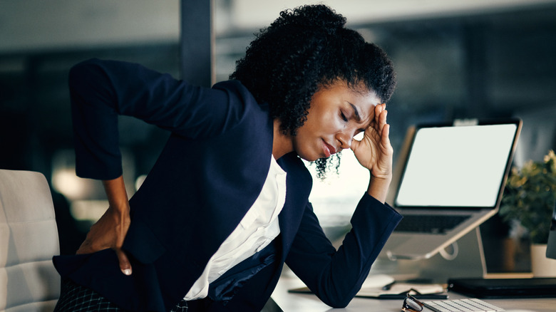 Woman at desk with lower back pain