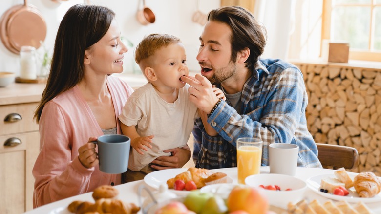 parents feeding their baby