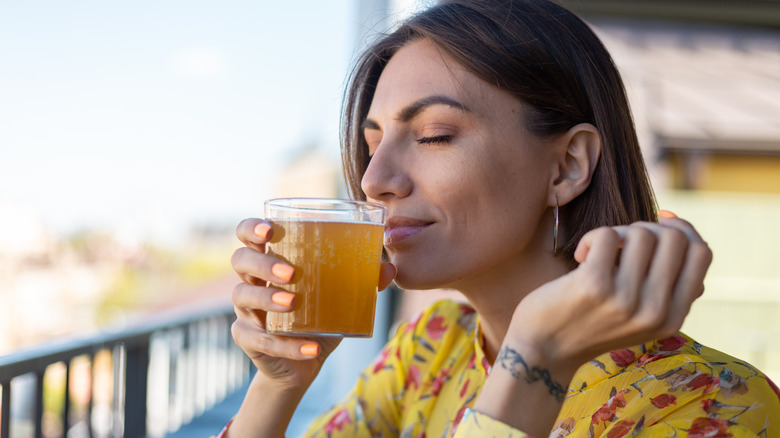 person enjoying a glass of kombucha