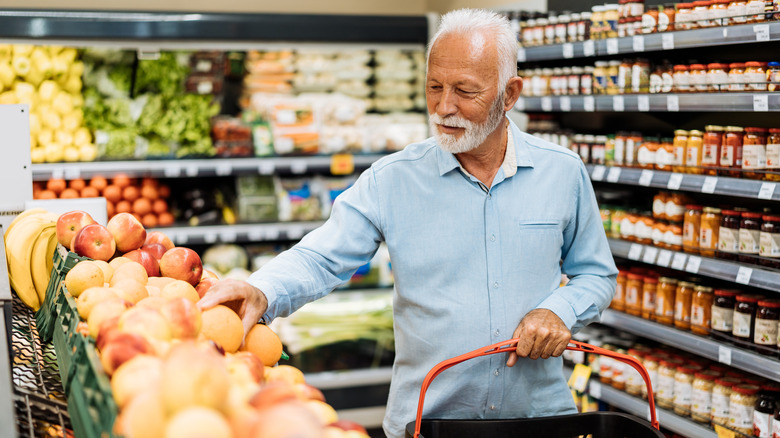 older man shopping in produce section of grocery