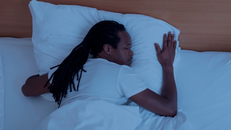Man sound asleep in bed