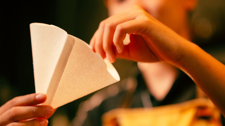 woman using a paper coffee filter