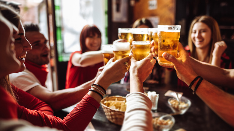 group of friends toasting beer mugs