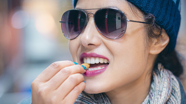 woman eating a nut