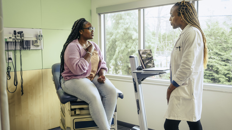 woman talking with doctor about her heartburn pain