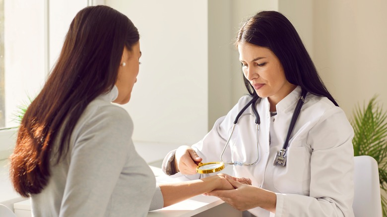 Woman receiving dermatological skin exam