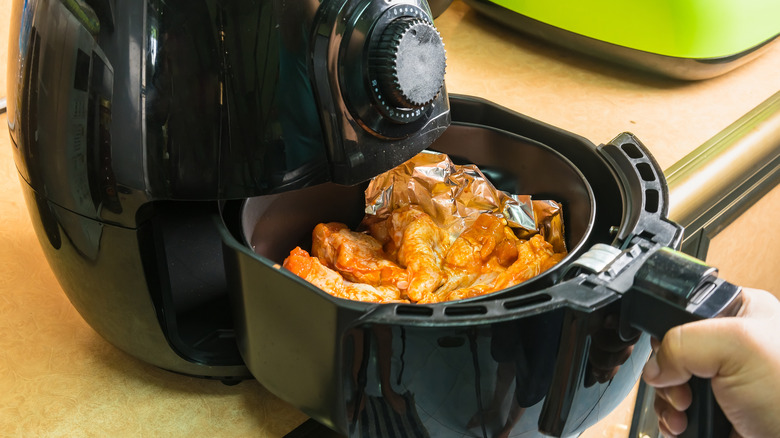Someone cooks with an air fryer