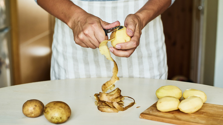 man peeling potatoes