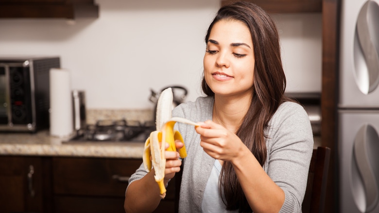 person peeling a banana