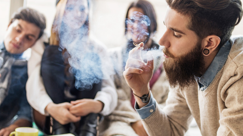 person smoking among friends