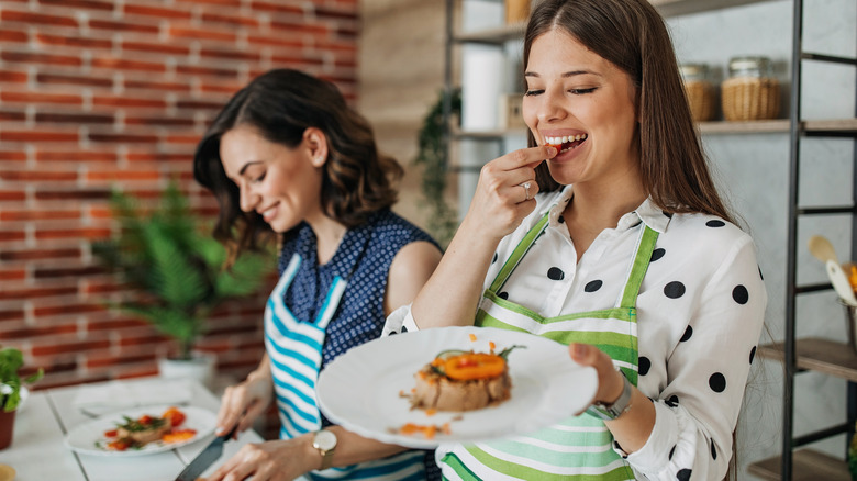 two women making light lunch in the kitchen