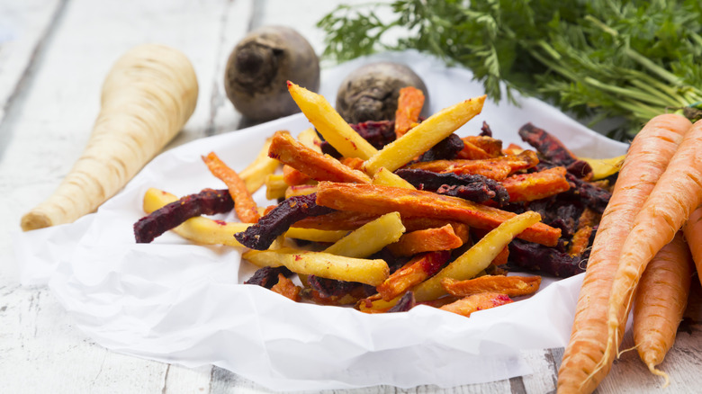 Roasted and sliced parsnips, carrots, and beets on a plate
