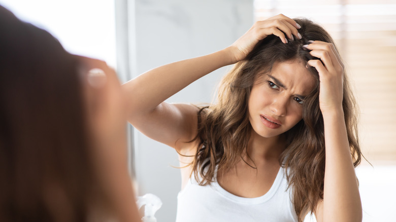 A woman struggles with hair loss