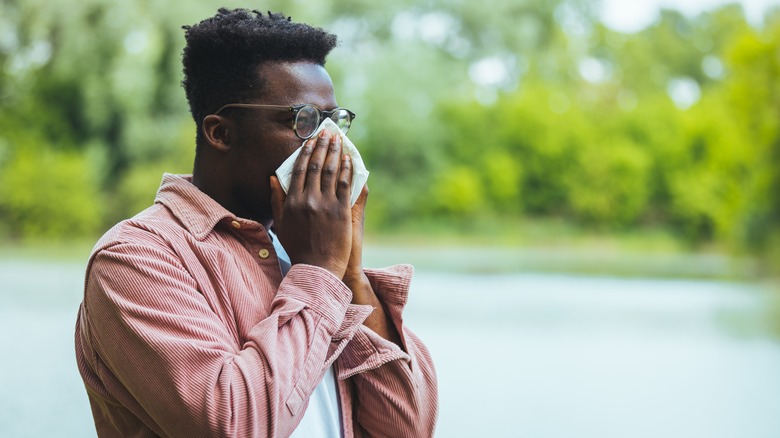 Man blowing nose