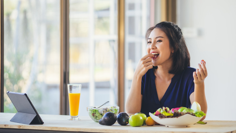 A woman eats a salad