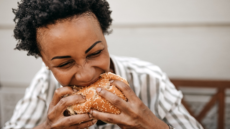 Woman biting into food