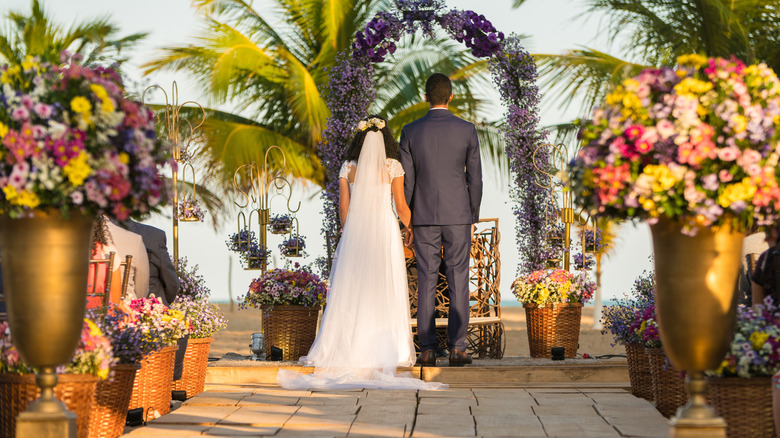 bride and groom standing at altar