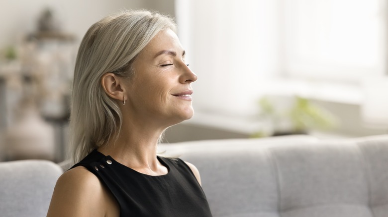 older woman smiling with her eyes closed