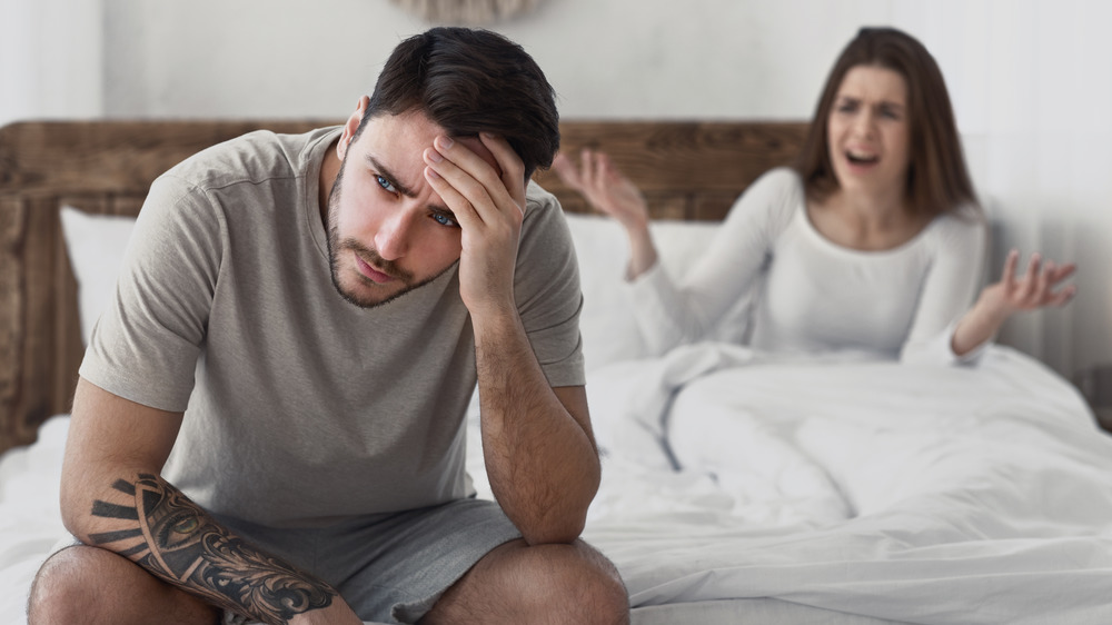 couple arguing in bed