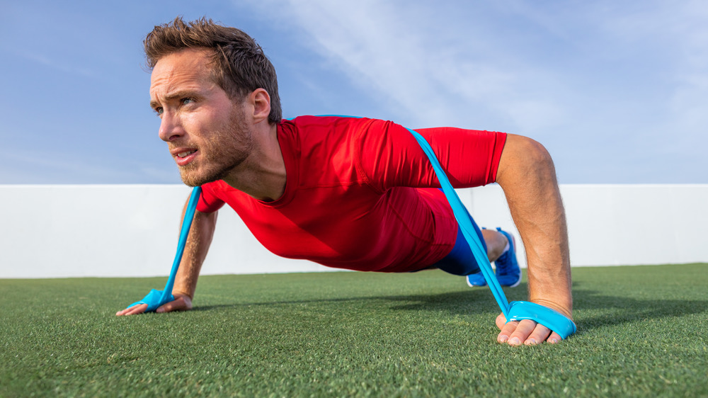 man doing banded pushups