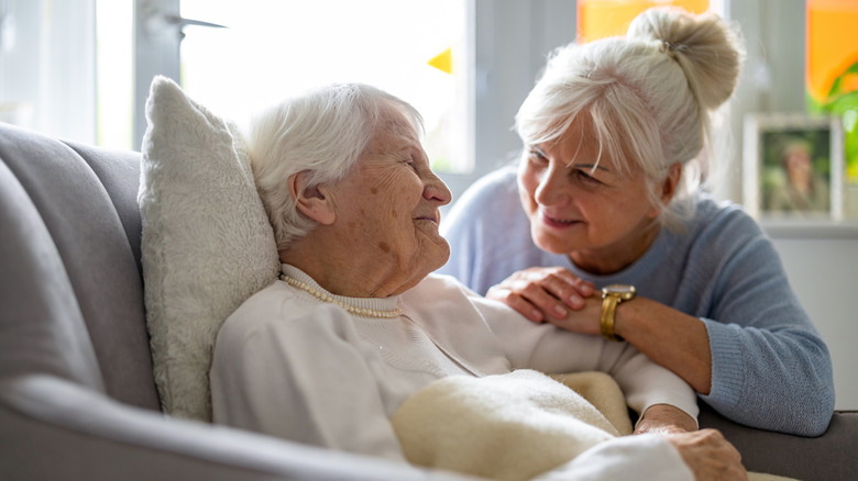An elderly woman and her caregiver in a nursing home