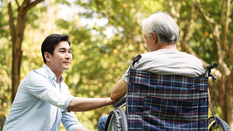 A young man sitting with an older man