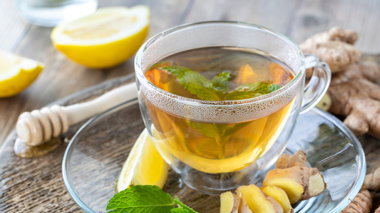 A cup of green tea and ginger root
