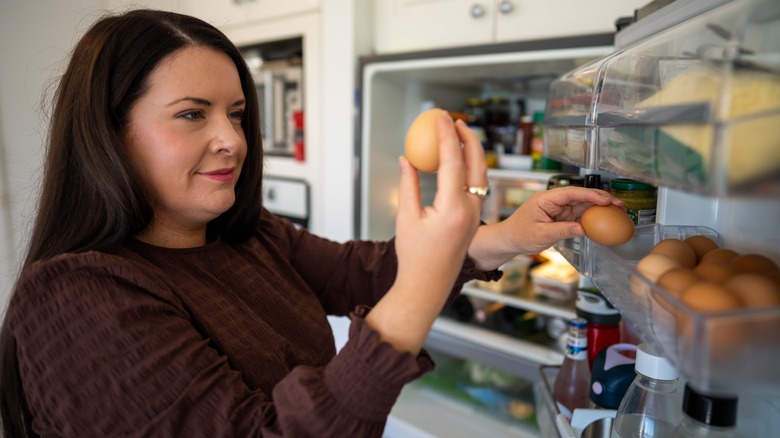 Woman taking eggs out of the refrigerator