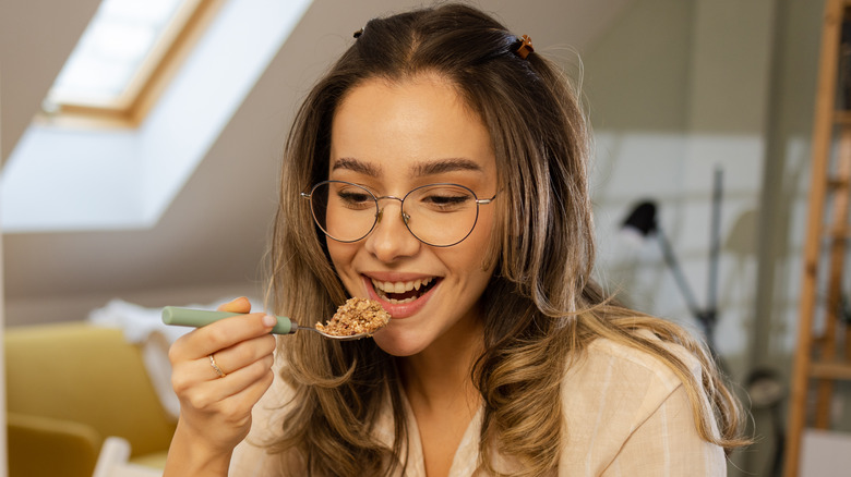 Woman eating from cereal bowl