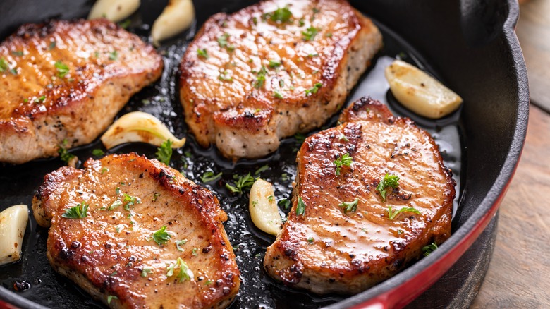 Cooked pork chops in skillet