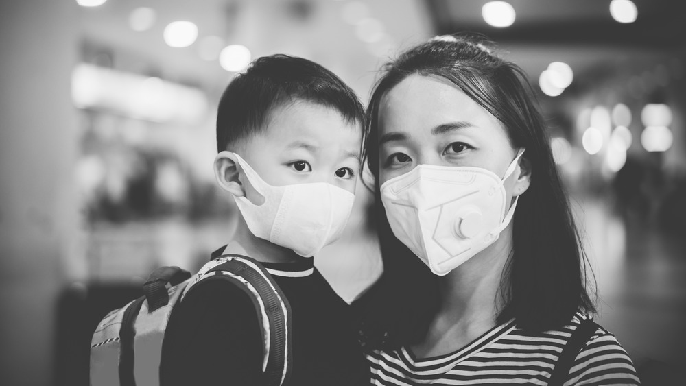Mother and child in N95 surgical mask