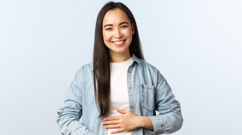 Woman holding stomach