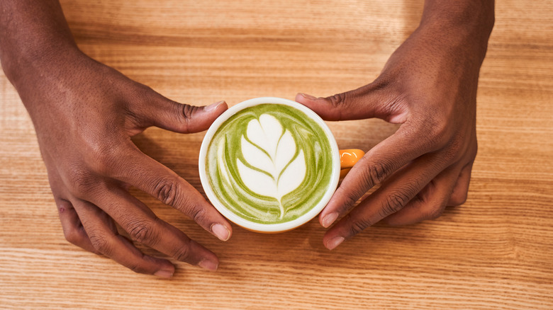 man holding matcha tea