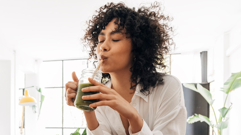 woman sipping healthy drink