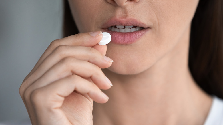 Woman taking water pill