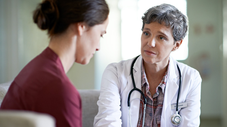 Concerned doctor looking at patient
