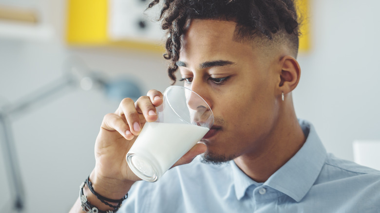 young man drinking glass of milk