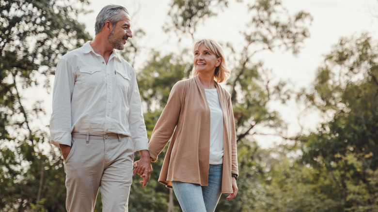 couple in 50s walking outside