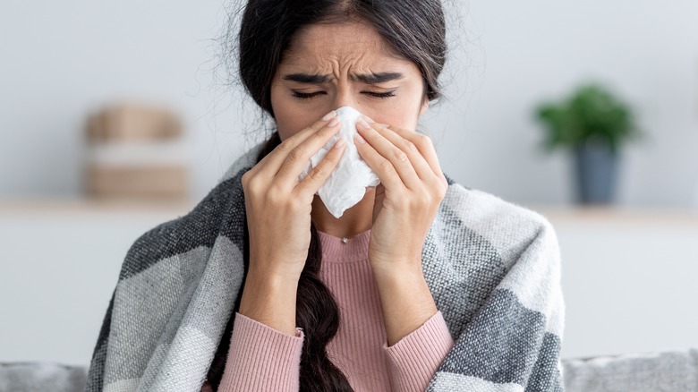 Woman blowing her nose