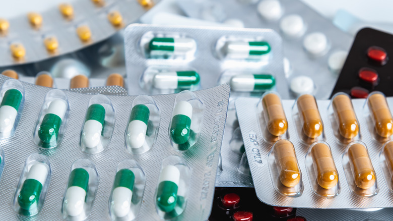 Assorted packages of different-colored pills