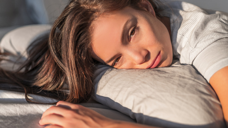 Fatigued woman resting on a pillow