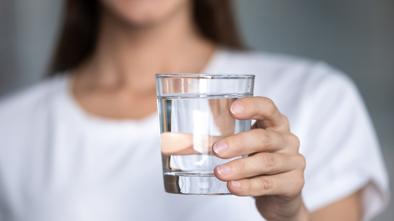 woman holding glass of water